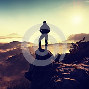 Man silhouette stay on sharp rock peak. Satisfy hiker enjoy view.