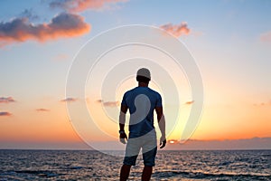 Man silhouette at sunset near the sea