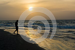 A man silhoutted on Kotu Beach, Gambia