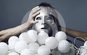 Man in a silver mask with a sheaf of nock bolls