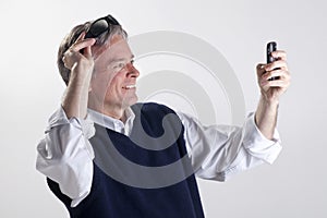 Man similing to cellphone