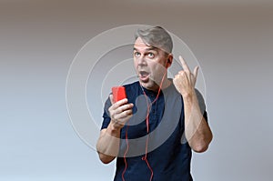 Man singing along to the tunes on his smartphone