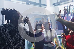 Man singing in microphone while clubbing