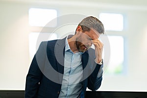 Man with sinus headache, tension or cluster headache, close up portrait. Head pain concept. Cephalalgia and migraine photo