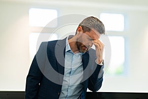 Man with sinus headache, tension or cluster headache, close up portrait. Head pain concept. Cephalalgia and migraine