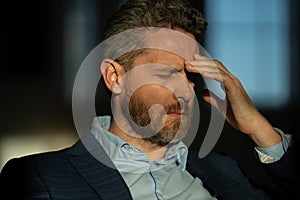 Man with sinus headache, tension or cluster headache, close up portrait. Head pain concept. Cephalalgia and migraine photo