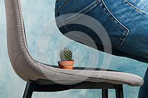 Man sit on chair with cactus. Hemorrhoids photo