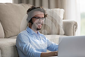 Man sit on floor leaned on sofa enjoy videocall talk