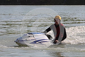 A man sit on the jet ski.