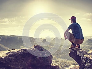 man sit and look out on the long Canyon. Tourist sit