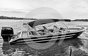 Man sit in motor boat or powerboat moored at sea shore in manaus, brazil. Water transport and vessel. Summer vacation