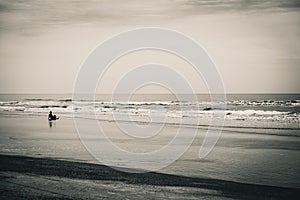 Man sits on beach in contemplation