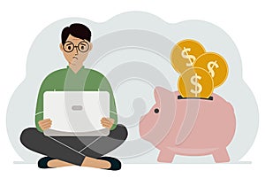 A man sits cross-legged with a laptop next to a pig piggy bank. Earning money, saving, saving money.