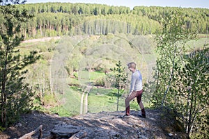 Man sits on the edge of a cliff