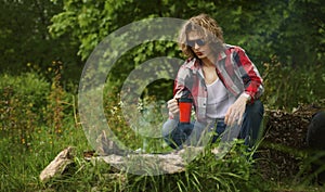 Man sits in front of bonfire