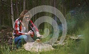 Man sits in front of bonfire