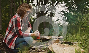 Man sits in front of bonfire