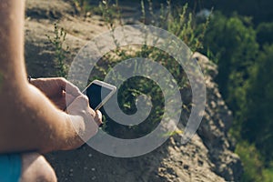 Man sits on the ground chating on the phone