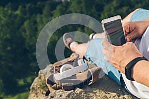 Man sits on the ground chating on the phone