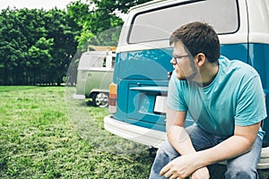 Man sits near van and thinks about something photo
