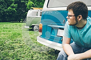 Man sits near van and thinks about something photo