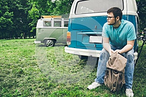 Man sits near van and thinks about something photo