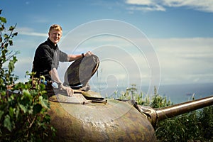 Man sits on the old tank tower