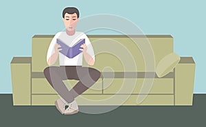 Man sits on sofa and reading book