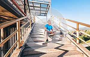 Man sits on stairs after workout set