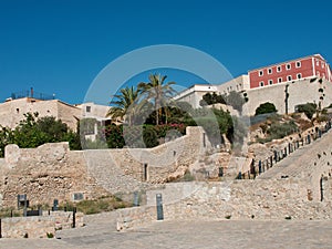 a man sits on a stone step overlooking the city of rhodes, rhodes