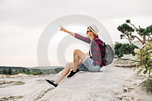 Man sits on the top of the mountain and enjoys the amazing view of the mountains