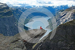A man sits on Trolltunga, Norway