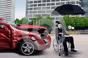 Man sits on wheelchair with damaged car