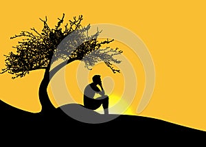 Man sitting alone under a tree on a mountain at sunset