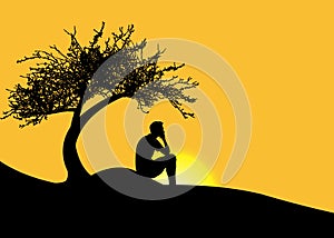 Man sitting alone under a tree on a mountain at sunset photo