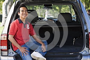 Man sitting in back of van smiling