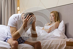 Man sitting on the bed with woman on the back