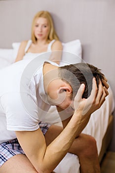 Man sitting on the bed with woman on the back