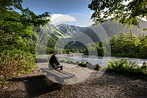 Man sitting on bench alone in Kamikochi national park