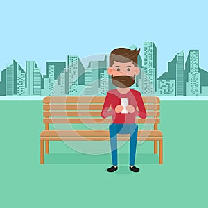 Man sitting on bench in the park and holding smartphone. Online communication.