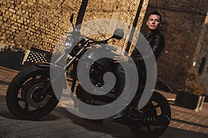 Man sitting on a cafe-racer motorcycle