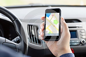 Man sitting car holding phone with interface nav