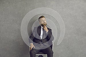 Man sitting on a chair and thinking of a business idea or professional solution to problem