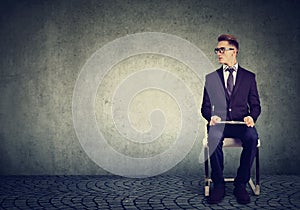 Man sitting on a chair waiting for job interview