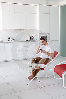 Man sitting in a chair watching tv holding remote control