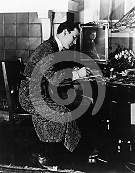 Man sitting in a chair and writing