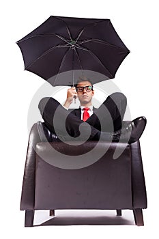 Man sitting in comfortable armchair with umbrella