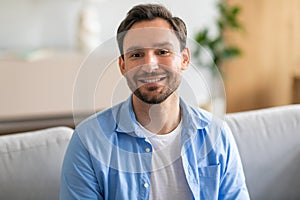Man Sitting on Couch Smiling, Home Interior