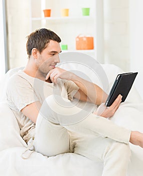 Man sitting on the couch with tablet pc