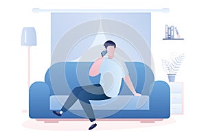 Man is sitting on the couch and talking on the phone, living room interior